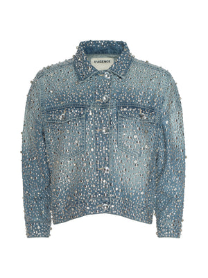 The Vangie Embellished Jean Jacket is a blue denim piece with crystal accents, a cropped high-low hem, silver studs throughout, front buttons, two chest pockets, and the L’AGENCE label on the inside tag.