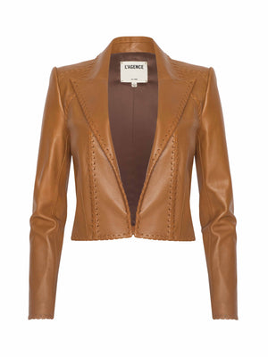 The Dulcie Leather Blazer is a brown, cropped leather jacket with long sleeves, visible whipstitch edging, an open front, and a collar label reading LAGENCE.