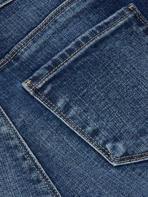 Close-up of the Kendra Cropped Flare Jean by L'AGENCE, featuring blue stretch denim with a back pocket, visible stitching, and faded areas that highlight the jeans’ textured details.