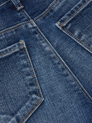 Close-up of the back pockets and seams on the Scottie Wide-Leg Jean, highlighting detailed stitching, classic stretch denim, and a faded blue fabric texture.