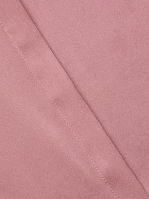 Close-up of the Bianca Silk Blouse by L'AGENCE in light pink charmeuse, featuring a diagonal seam with visible stitching. The fabric is soft and smooth, highlighting the blouse's luxurious texture and detailed craftsmanship.