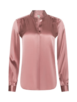 The Bianca Silk Blouse by L'AGENCE is a long-sleeved, light pink top with a mandarin collar, v-neckline, buttoned cuffs, a relaxed fit, and a smooth, shiny silk finish for an effortlessly elegant look.