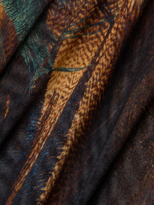 Close-up of the Elowen Mesh Bodysuit by L'AGENCE, featuring a sheer fabric with a detailed, multicolored feather-inspired print in teal, brown, orange, green, and black for an organic look.