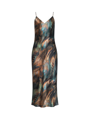 The Seridie Silk Slip Dress by L'AGENCE is a sleeveless, ankle-length slip dress with thin spaghetti straps, a fitted bias-cut silhouette, and an abstract multicolored brown, teal feather print, and black pattern.