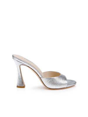 The Avery Leather Open-Toe Mule features silver lizard-embossed leather with a textured metallic finish, sculpted heel, and open toe, showcased against a white background.