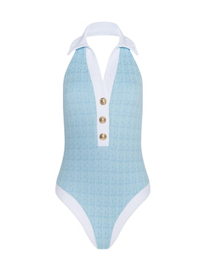 The Natalya Collared One-Piece Swimsuit features a light blue bouclé fabric, halter neck, white collar and trim, three front decorative buttons, and offers moderate bottom coverage.