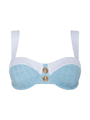 The Alexandria Bikini Top is a powder blue and white balconette style in bouclé swim fabric, featuring wide white straps and two decorative gold buttons at the center front.