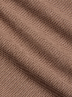Close-up of light brown ribbed fabric with diagonal lines and a soft texture, featuring fine ridges and a smooth surface—perfect for the sculpted fit of the Nica Scoopneck Bodysuit.