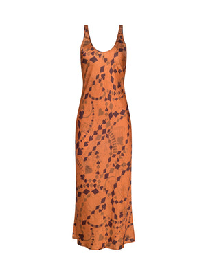 The L'AGENCE Akiya Satin Maxi Dress is a sleeveless, burnt orange bias-cut tank dress with a scoop neckline and abstract brown geometric and floral patterns, shown on a white background.
