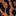 Close-up of a fabric with a leopard print pattern featuring irregular black spots on a brown and tan background.