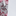 A close-up of a fabric with a red, black, and white floral pattern on the left side, next to a textured white surface on the right.